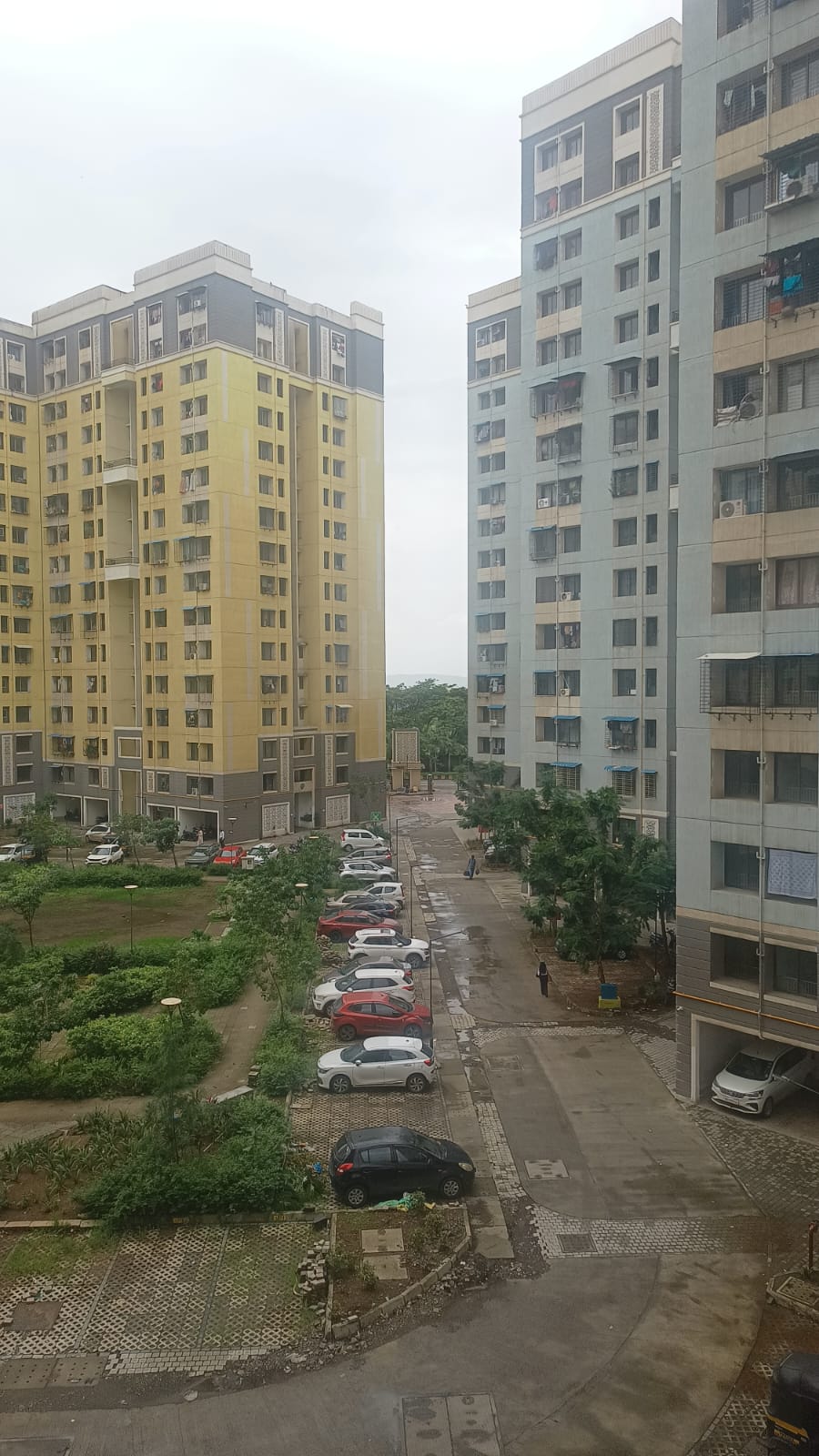 Landscaped garden and car parking area inside Ananta Towers Ulwe society
